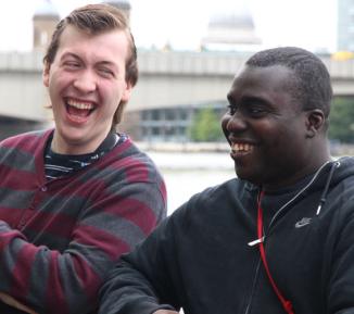 Two men sat outside laughing together